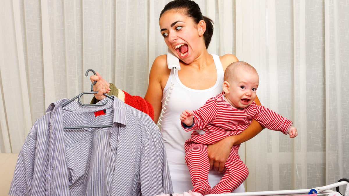 woman holding baby and screaming looking at a blouse