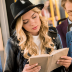 Girl reading book in bus
