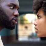 Young afro-american couple arguing outdoor, misunderstanding, jealous spouse.