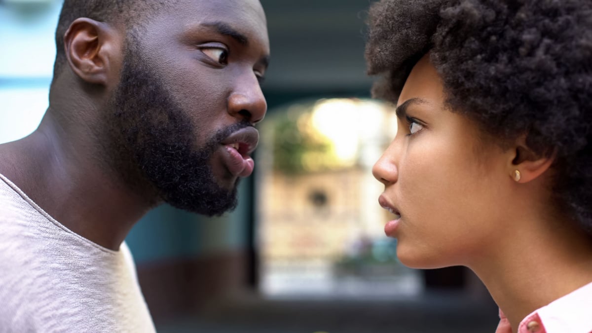 Young afro-american couple arguing outdoor, misunderstanding, jealous spouse.