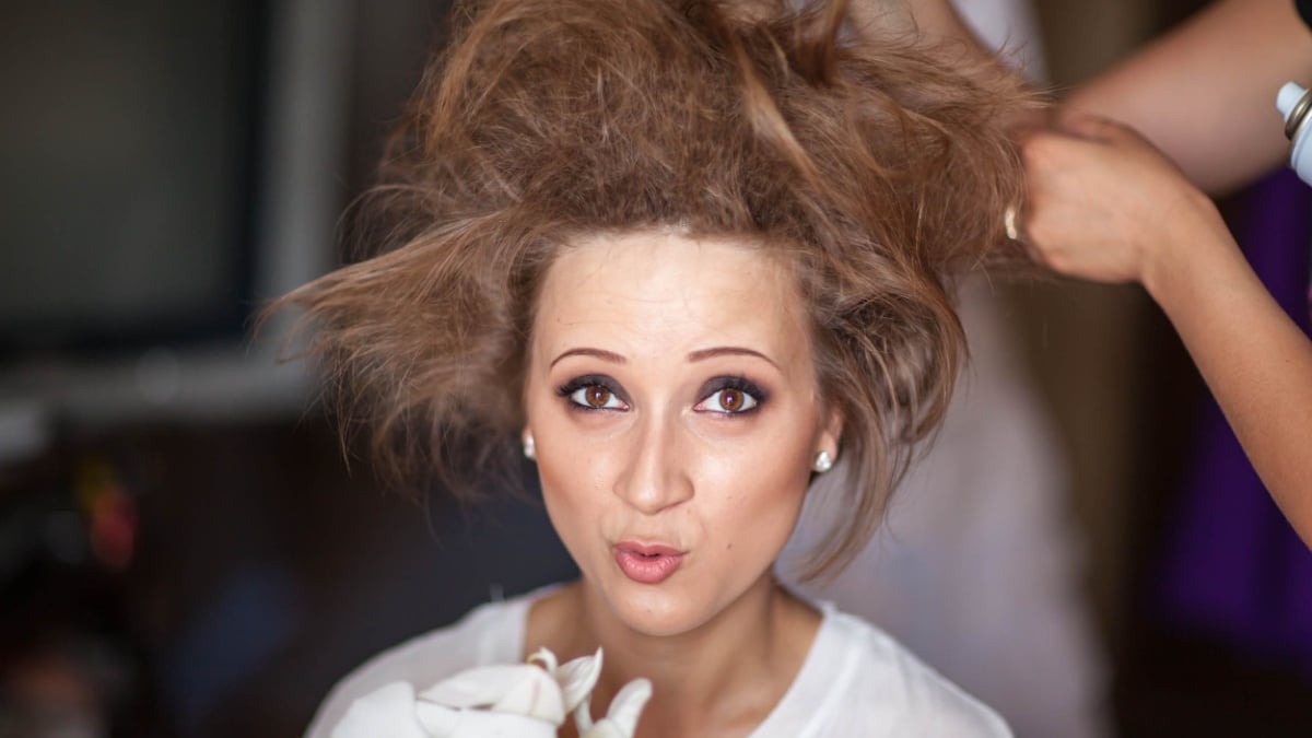 Wedding day. Portrait of a young woman, a bride on the wedding day. Preparation, makeup, do her hair, the hair are crazy, do bouffant comb. The image of orchid flowers.