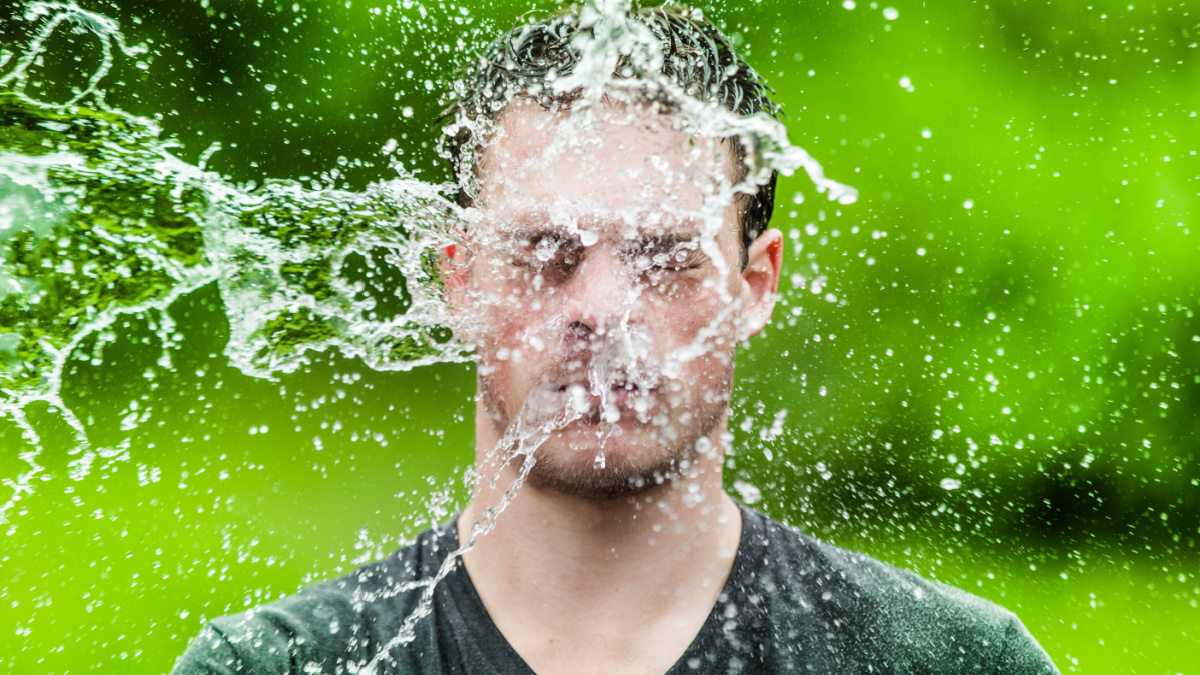 Young Adult That Got Completely Drenched with Green Background.