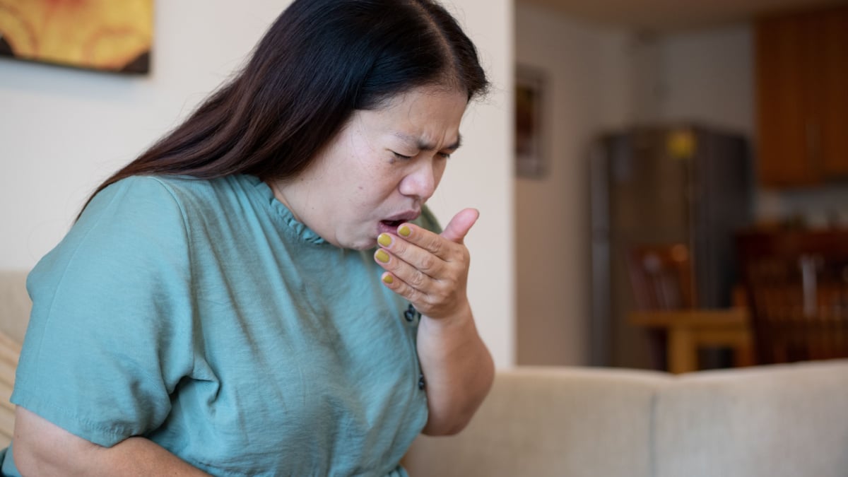 woman coughing sick.