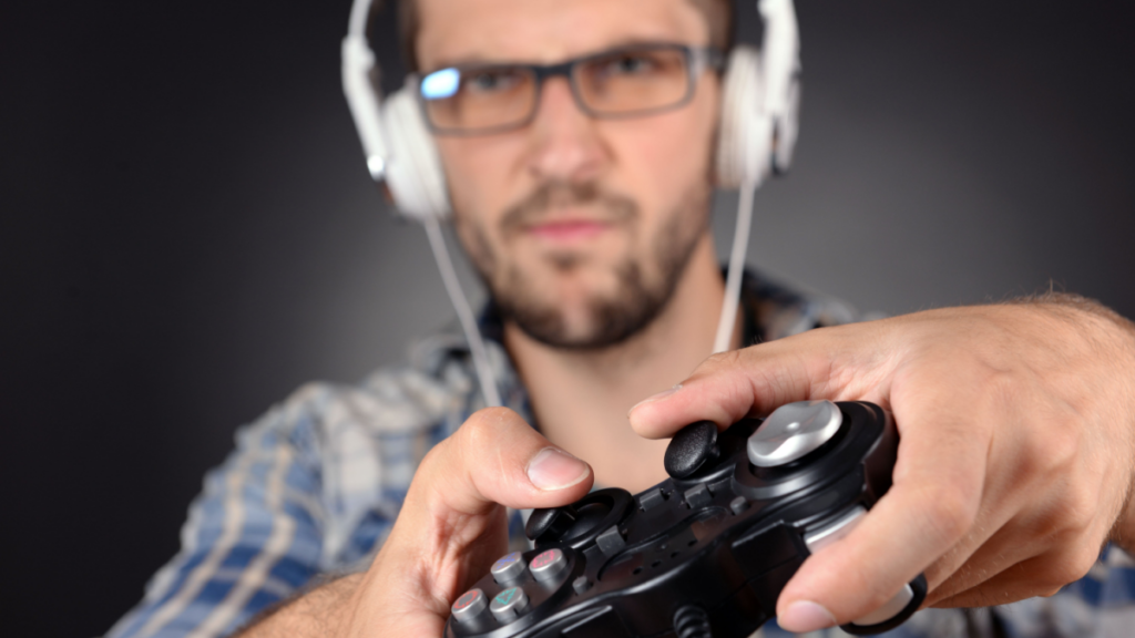Young man playing video games close up.