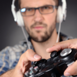 Young man playing video games close up.