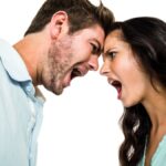 Couple screaming and arguing on white screen.