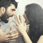 attractive angry couple fighting and shouting at each other.