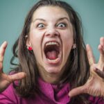 Angry woman screaming with rage, furious and dangerous.