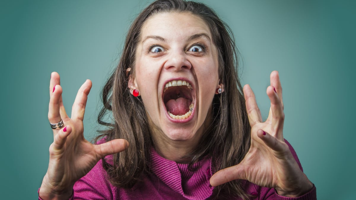 Angry woman screaming with rage, furious and dangerous.