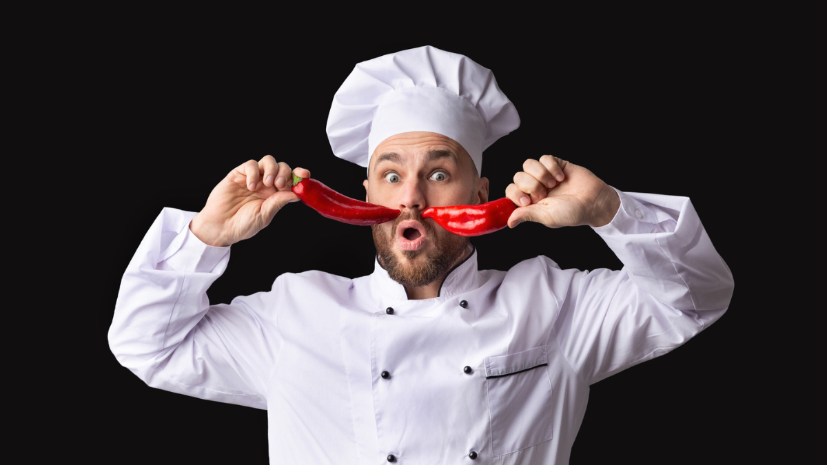 Funny Chef Posing With Food Having Fun Over Black Background