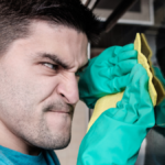 angry Adult man cleaning oven.