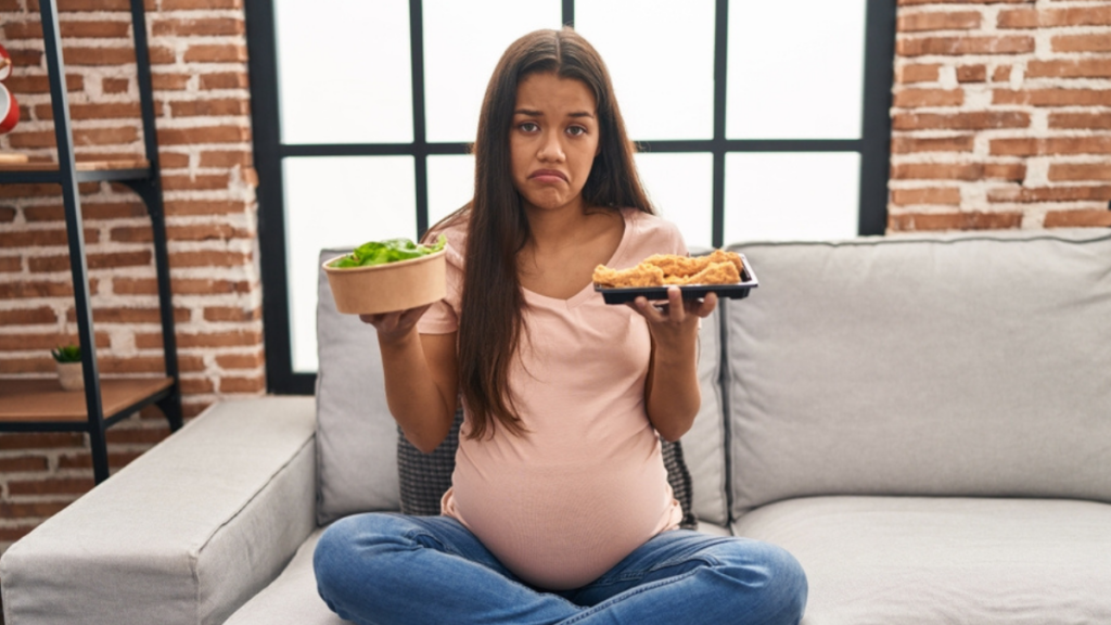 Young pregnant woman craving for food at home depressed and worry for distress, crying angry and afraid. sad expression.