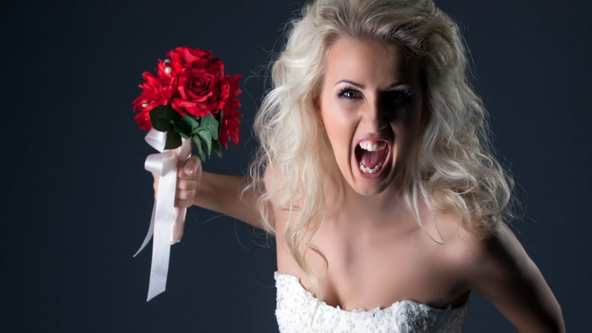 Emotional bride screaming looking at camera.