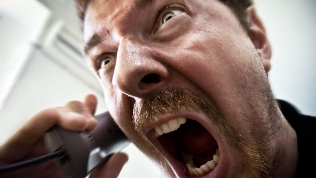 Stressed Stock Broker Screaming on the Phone.