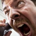 Stressed Stock Broker Screaming on the Phone.