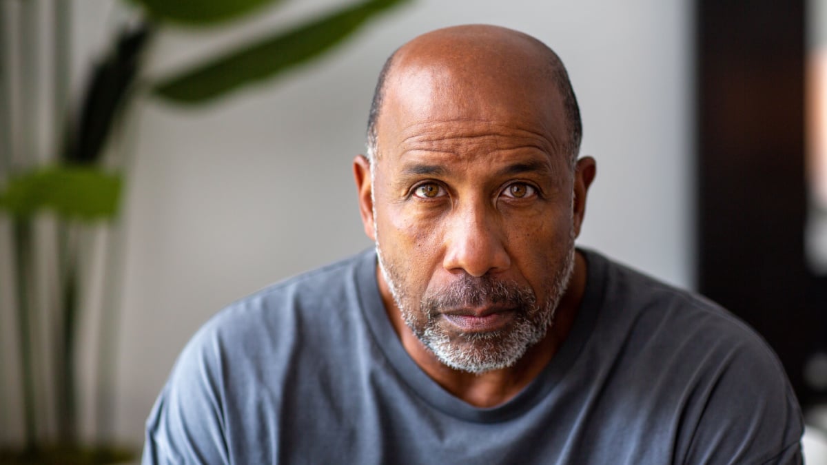 Handsome older man looking at the camera smiling.