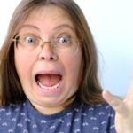 close-up of funny face, mature charismatic woman 50 years old with grimaces.