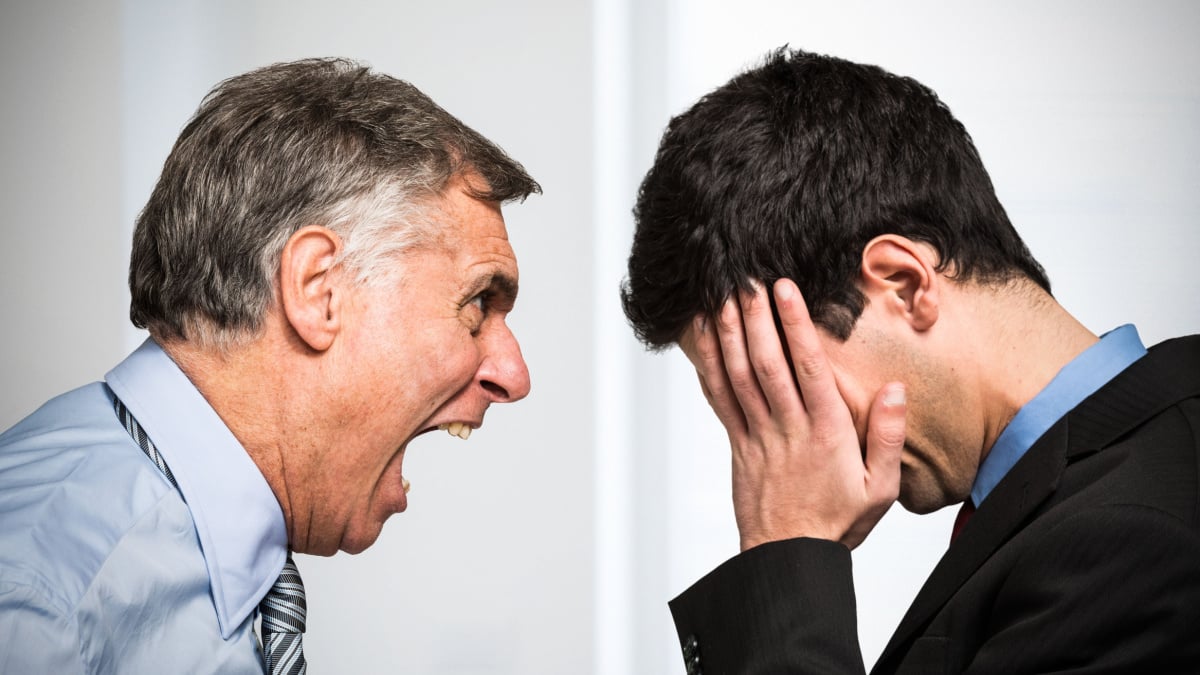 Angry boss shouting to an employee.