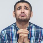 Please help me! Bearded man need a help. Isolated on gray background, studio shot.