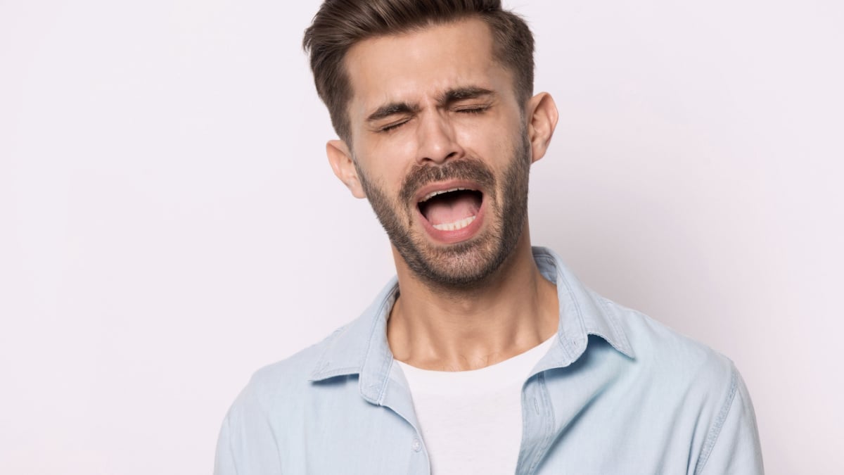 Head shot portrait of hysterical face expressions guy closed eyes screaming or whines isolated on grey white studio background, nagging man feeling desperate, singer singing song expressively concept.