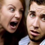 Young woman yells at man with beard.
