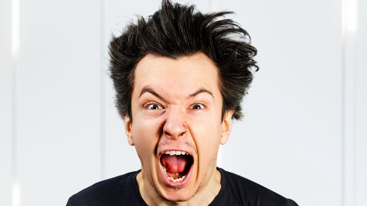 Sad anger young guy look in camera and cry with open mouth and scream, on white background.