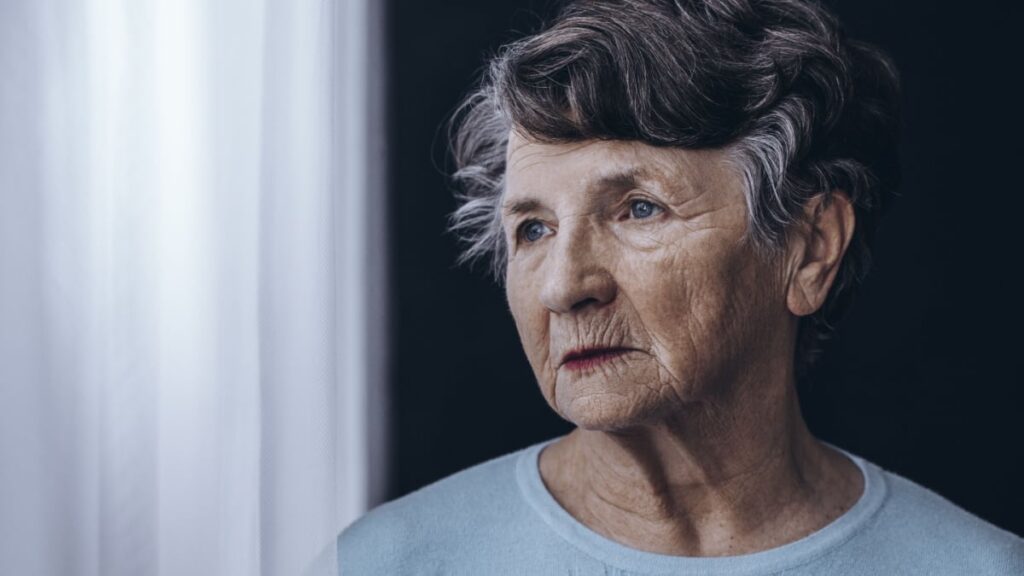 Elderly woman with memory problem spending time in nursing home.