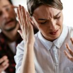 Husband and wife are arguing at home. Angry man is yelling at his wife.